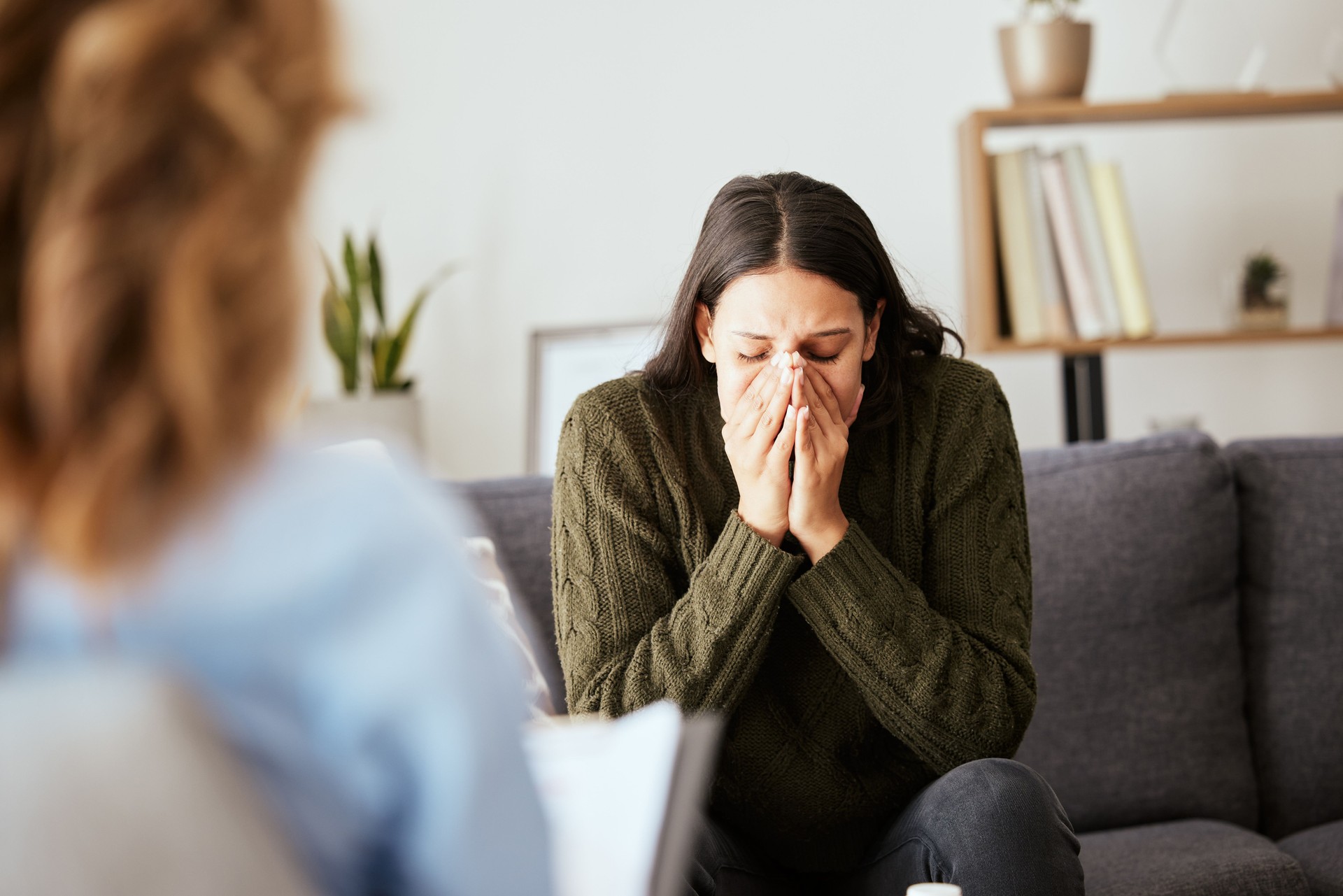 Shot of a young woman having a therapeutic session with a psychologist